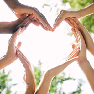 Hands, heart and emoji with a group of people outdoor together in summer for love or solidarity. Social media, icon and hand gesture with friends outside in nature for sustainability or bonding.